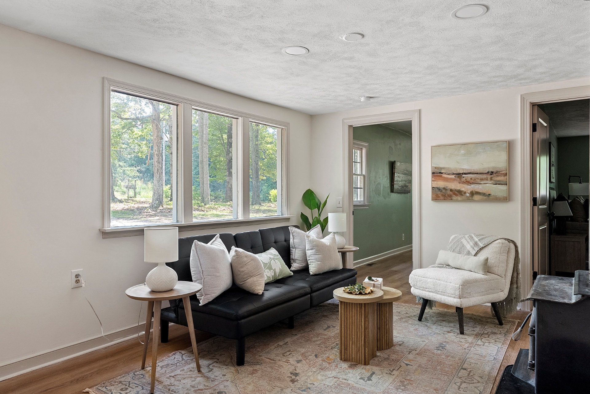 Renovated living room with restored hardwood and natural light