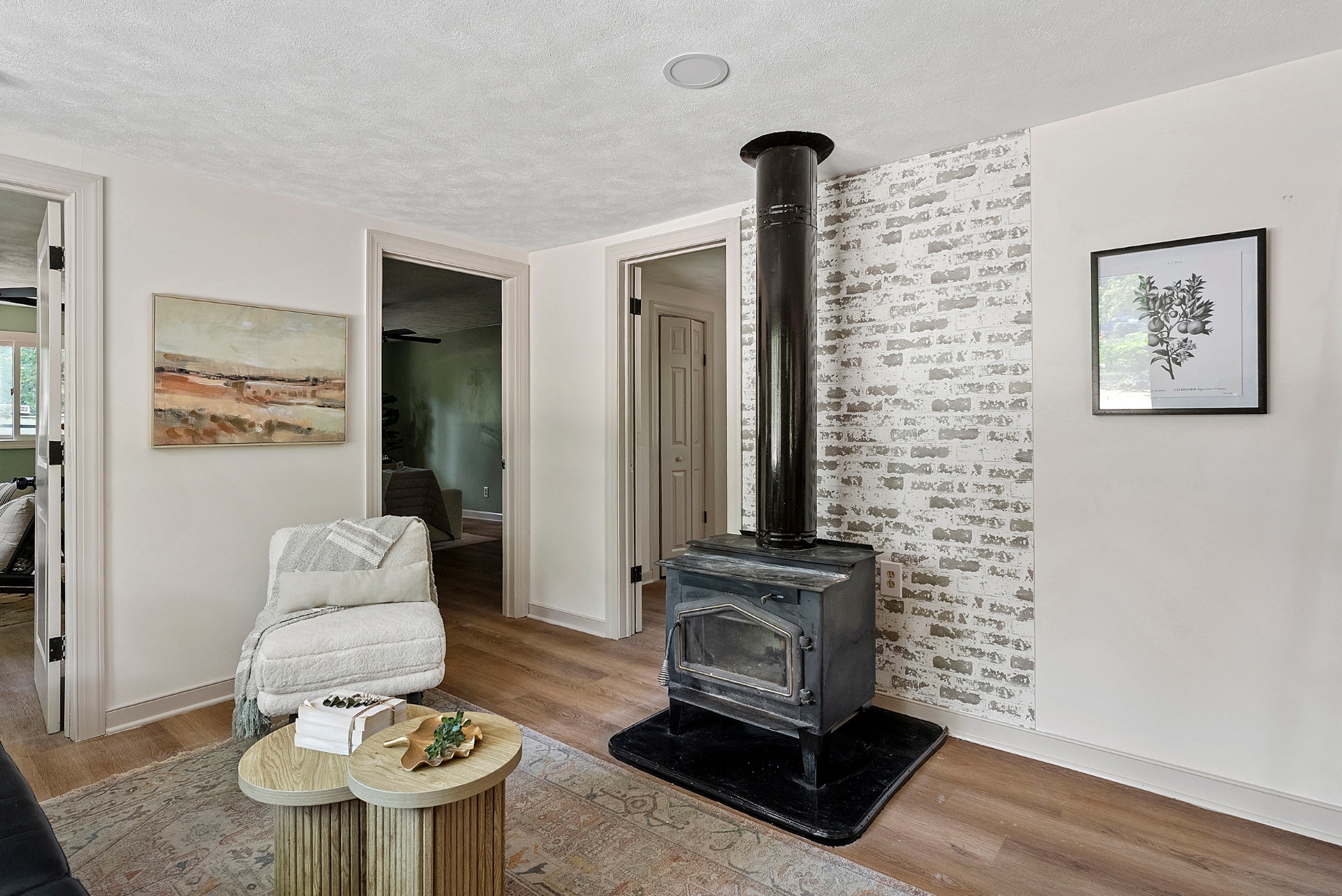 Cozy living area with wood stove and brick accent wall